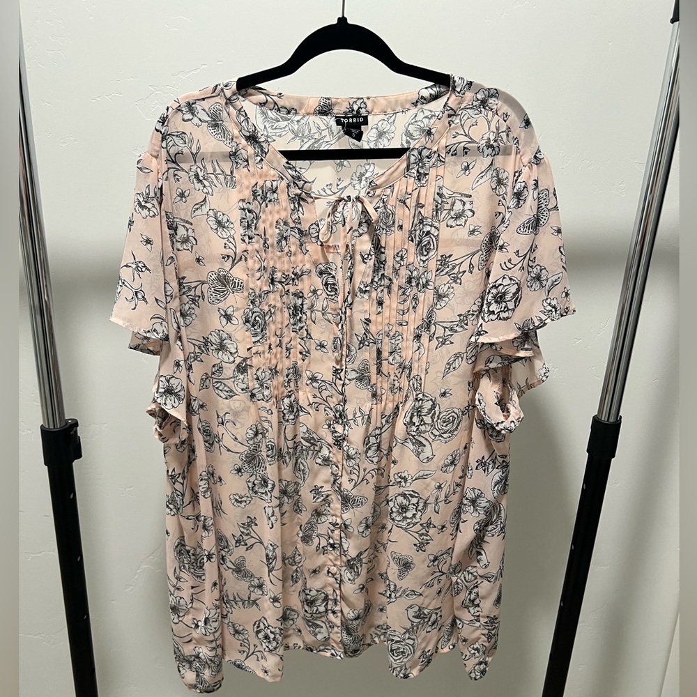 Torrid, Pink with Black Flowers blouse. It is a Size 5. It is sheer.